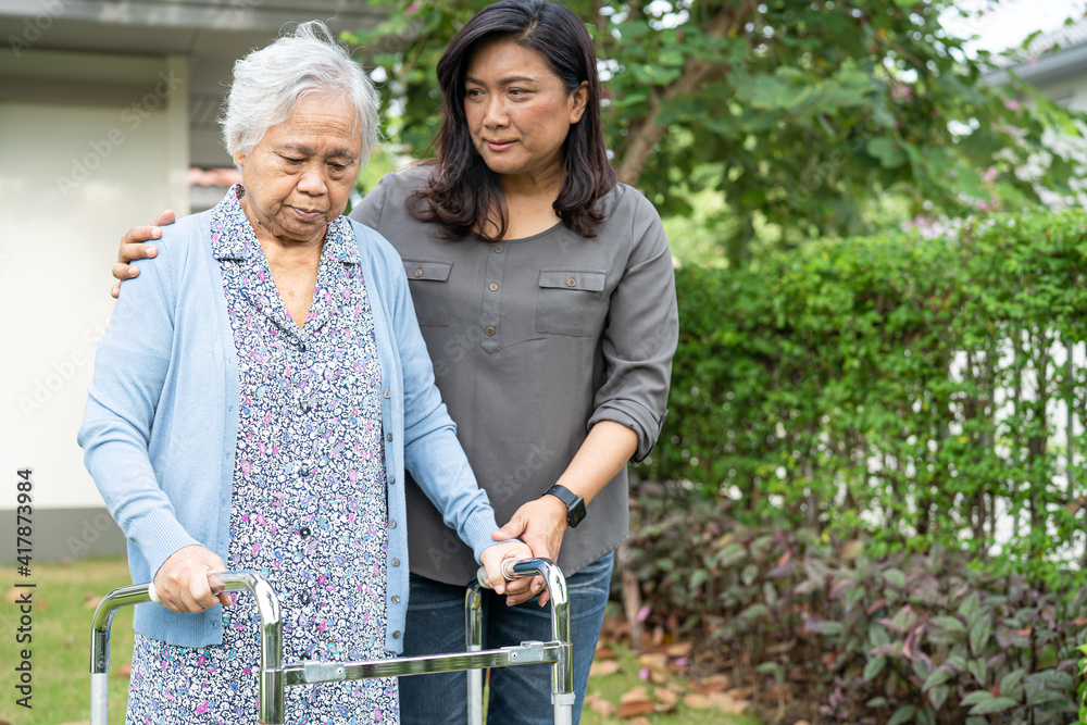 a caregiver helping someone using a walker